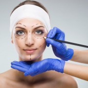 Beautiful woman with plastic surgery, depiction, plastic surgeon hands